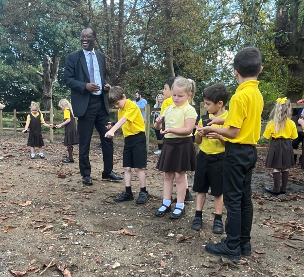 Rt Hon Kwasi Kwarteng, MP for Spelthorne, scattering wildflower seed alongside children from Littleton C of E Infant School